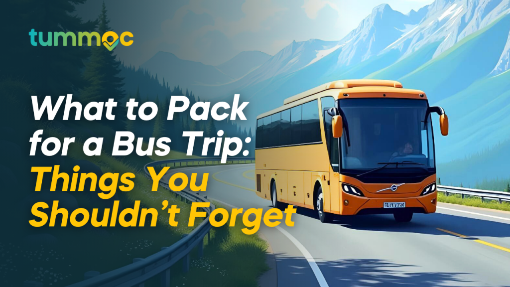 A yellow luxury bus driving along a winding road with scenic mountains and lush greenery in the background. The text overlay reads 'What to Pack for a Bus Trip: Things You Shouldn’t Forget,' along with the Tummoc logo in the top left corner